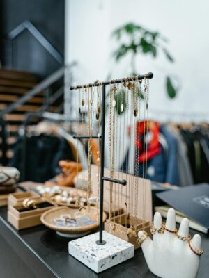 Chic jewelry presentation in a stylish boutique setting with necklaces and rings on display.