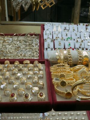 Showcase of elegant gold and silver jewelry in an Istanbul market's display case.
